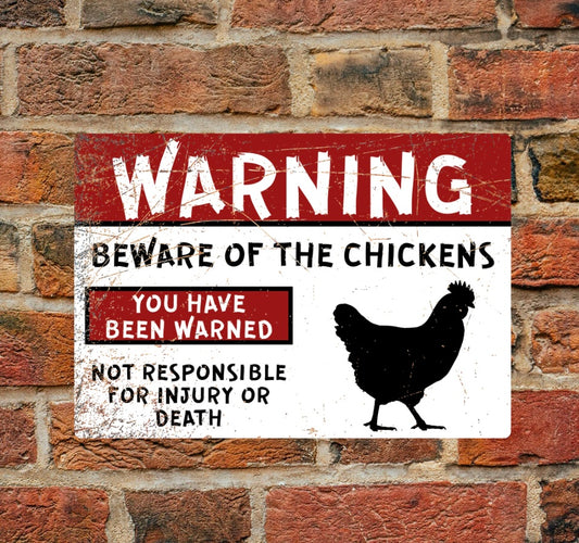 Warning - Beware of the Chickens - A4 Aluminium sign mounted on brick wall. Features bold red and black text with chicken silhouette for safety alerts.