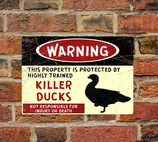A4 Aluminium Killer Ducks Warning Sign mounted on brick wall. Features bold red and black text with duck silhouette for safety alert.
